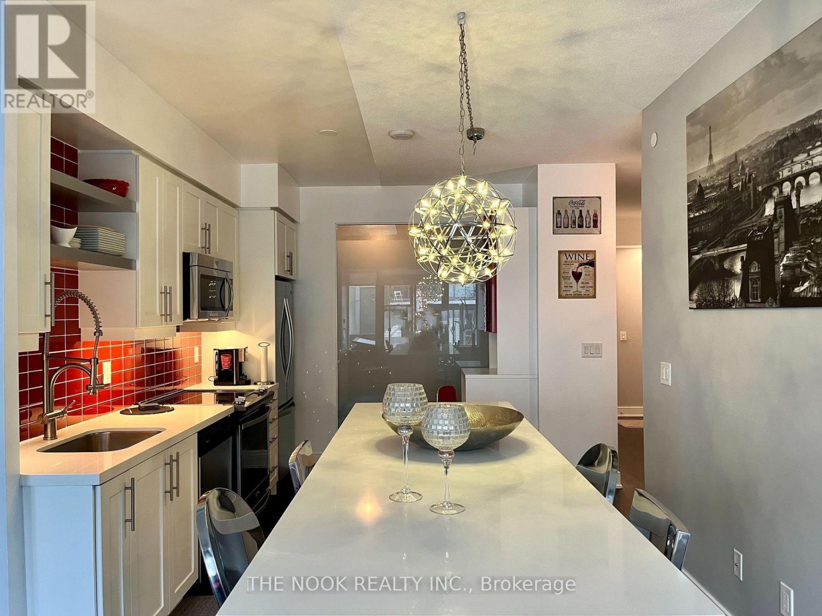 A modern kitchen with a dining table and chairs.