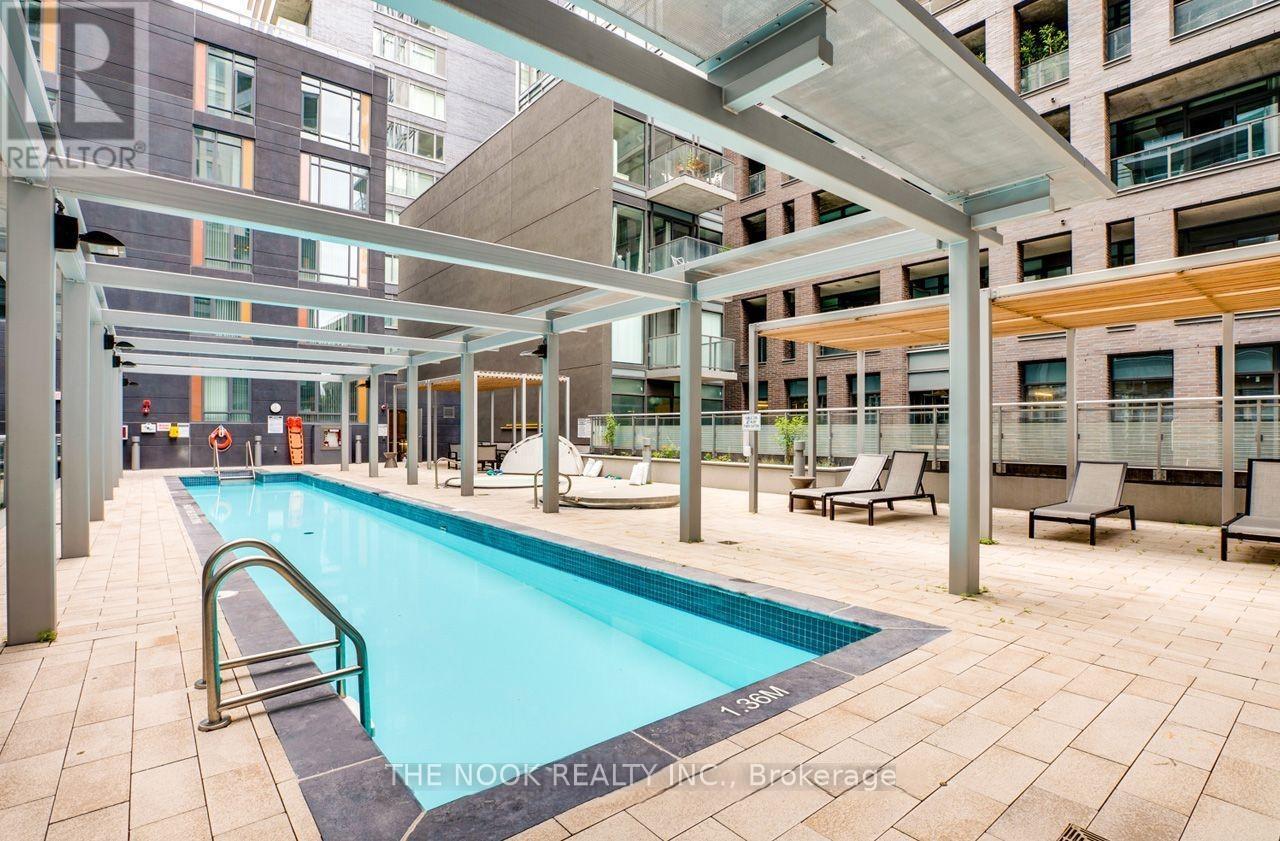 A swimming pool in a residential area with a glass ceiling.