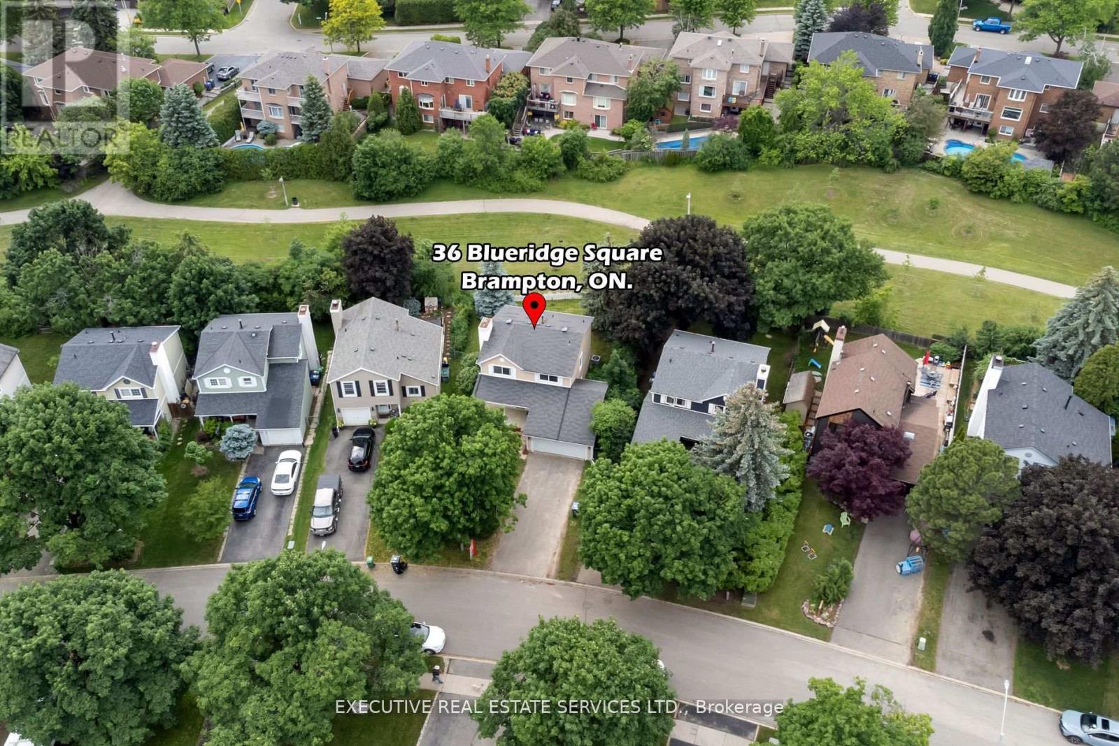 An aerial view of a residential area with houses and trees.