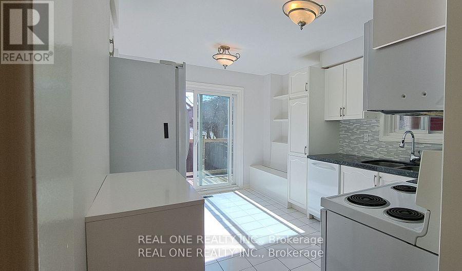 A kitchen with white cabinets and a black stove top oven.