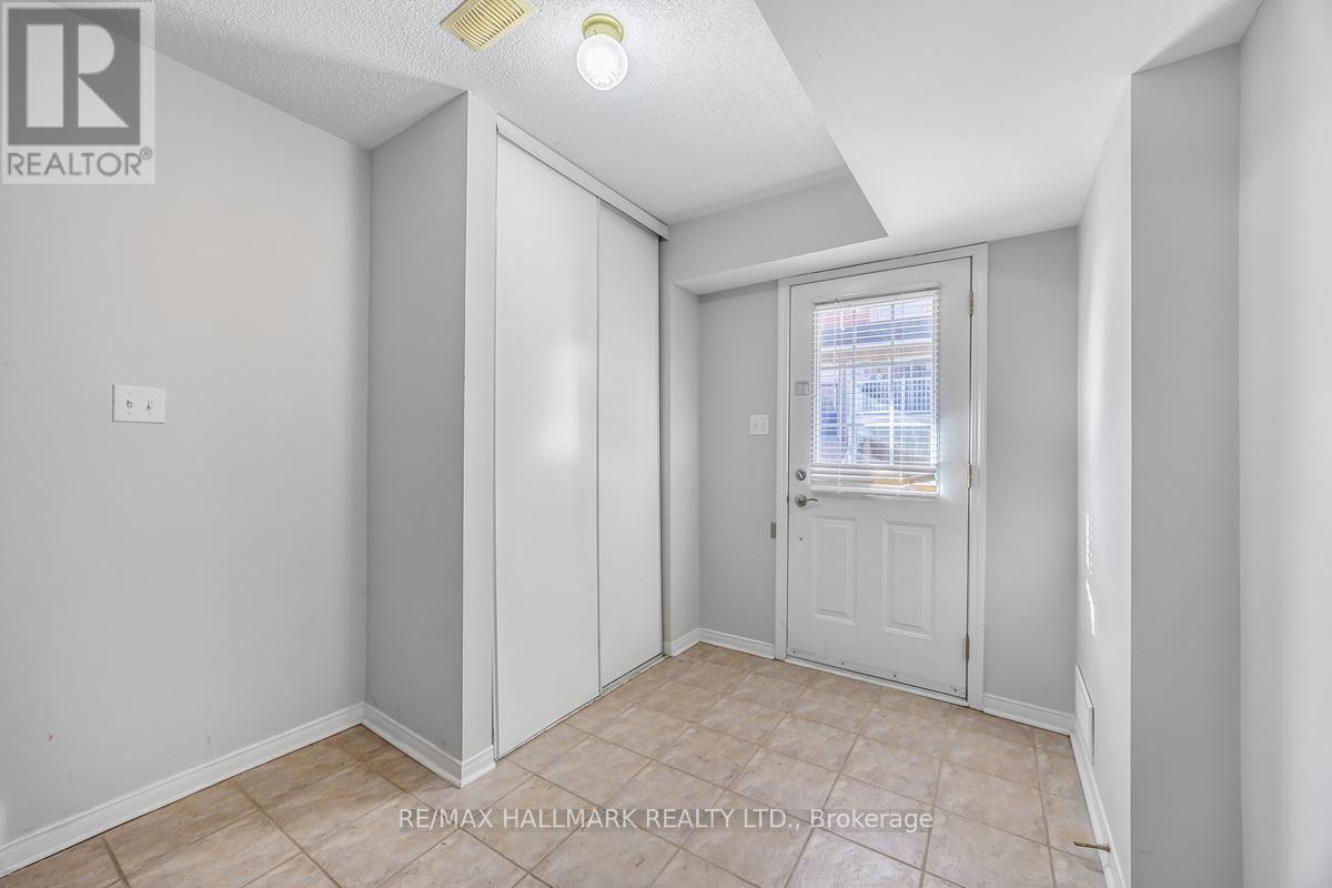 A room with a door and a window with blinds.