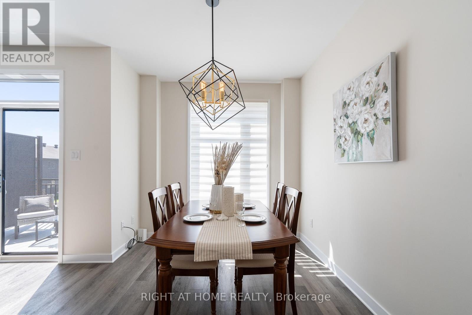 A dining room with a wooden table set for six.