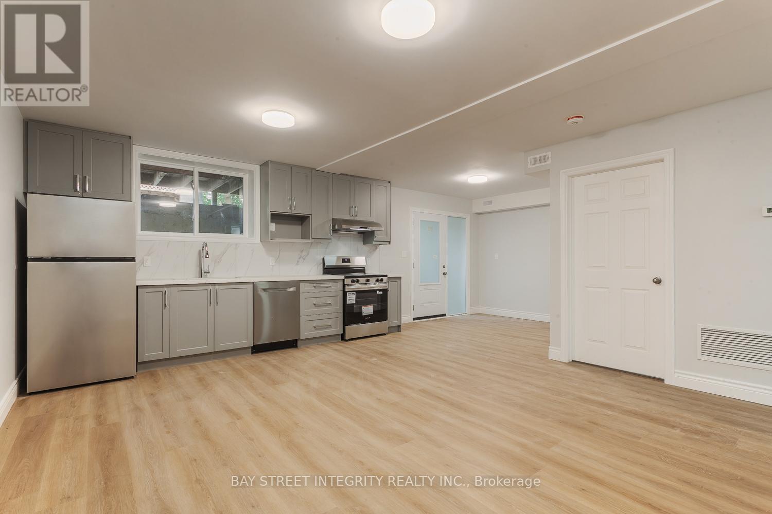 A kitchen with wooden floors and white walls.