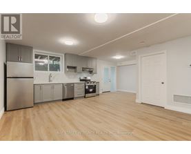 A kitchen with wooden floors and white walls.