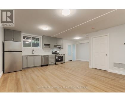 A kitchen with wooden floors and white walls.