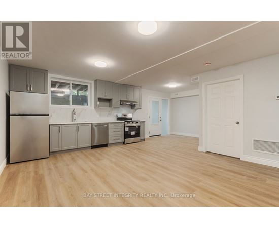 A kitchen with wooden floors and white walls.
