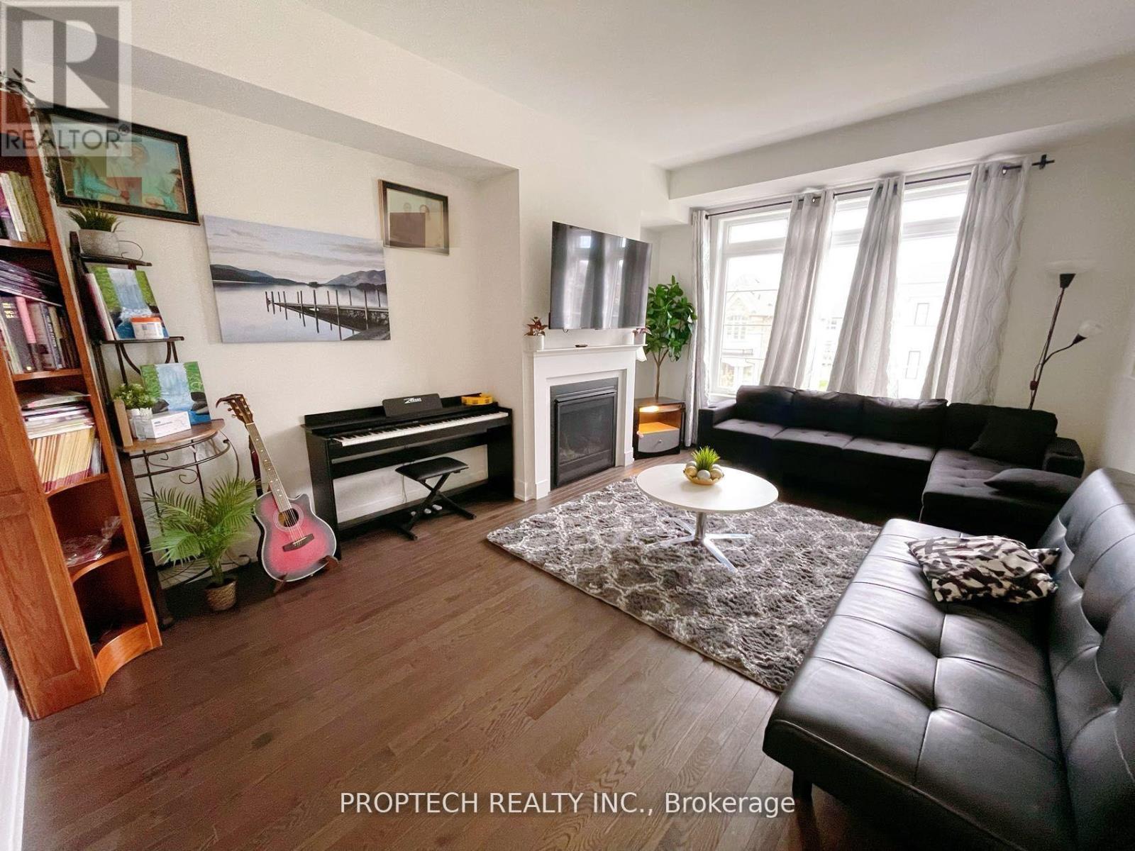 A living room with a fireplace and a guitar.