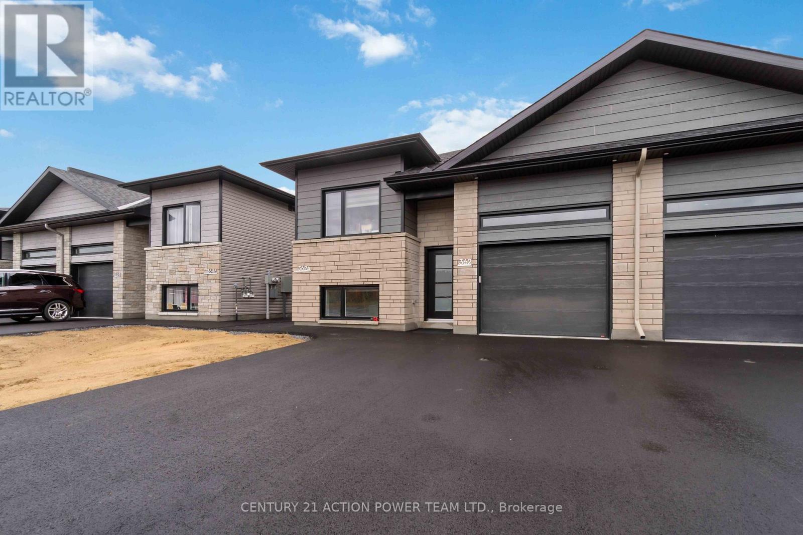 A real estate image of a house with a car parked in front.