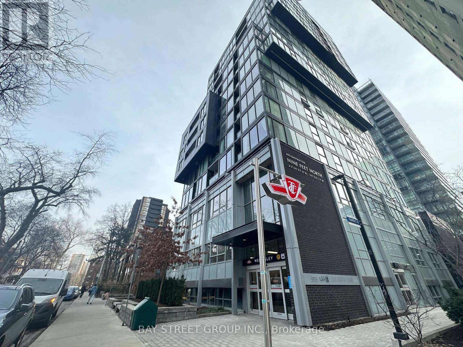 A modern building with a glass facade and a sign that reads "Bay Street Group Inc.".