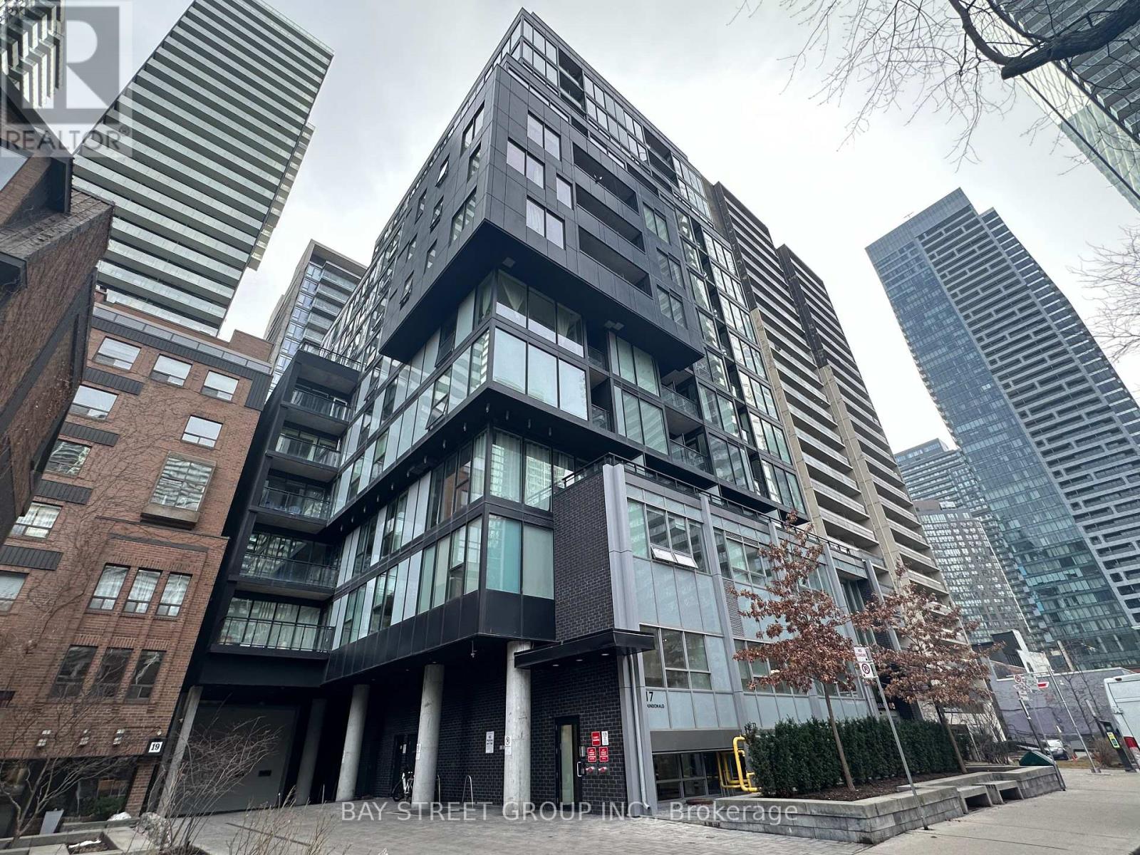 A modern building with a glass facade is the focal point of the image.
