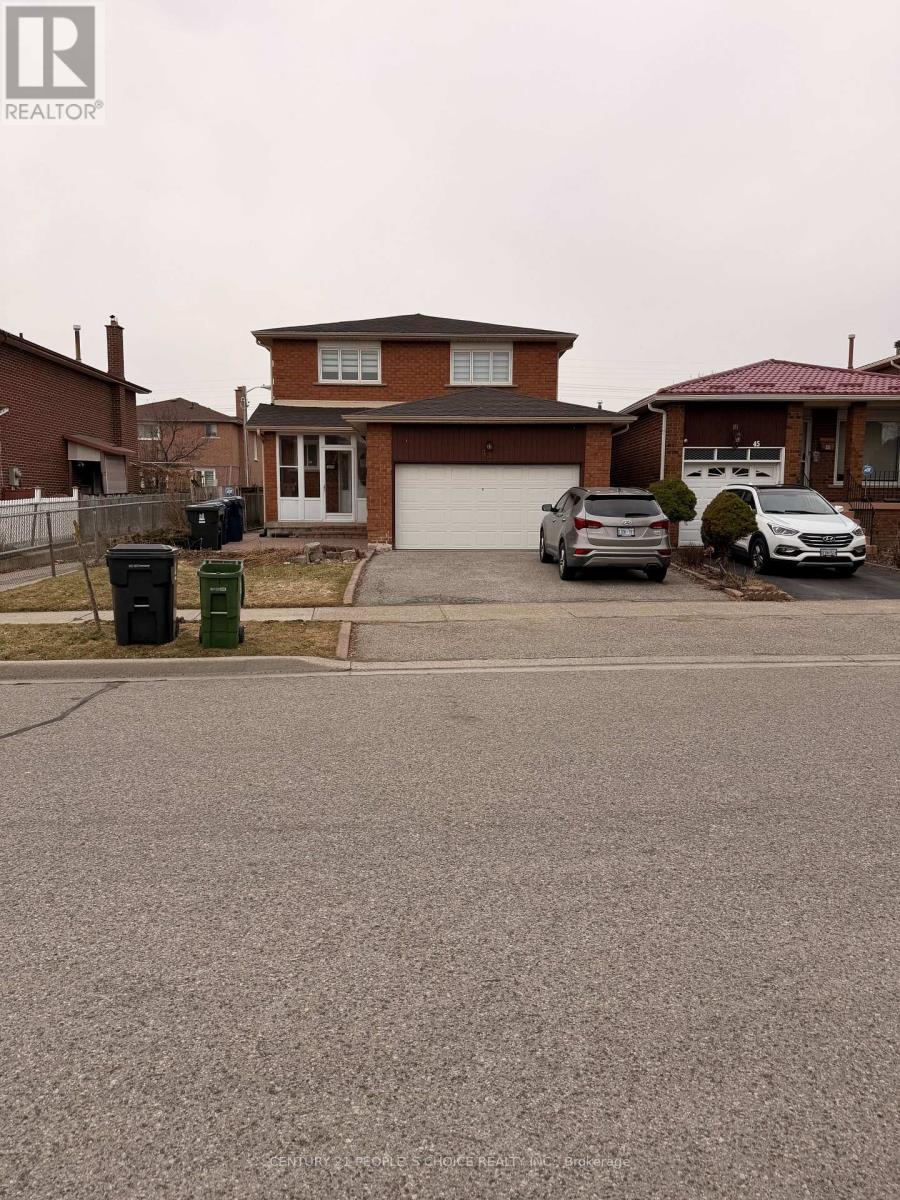 A house with a brown roof and a driveway in front of it.