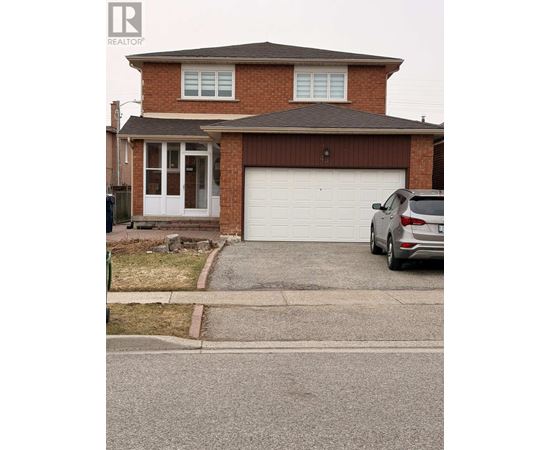 A house with a garage and a car parked in front.
