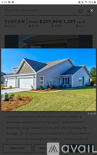 A blue house for sale with a covered rear porch.