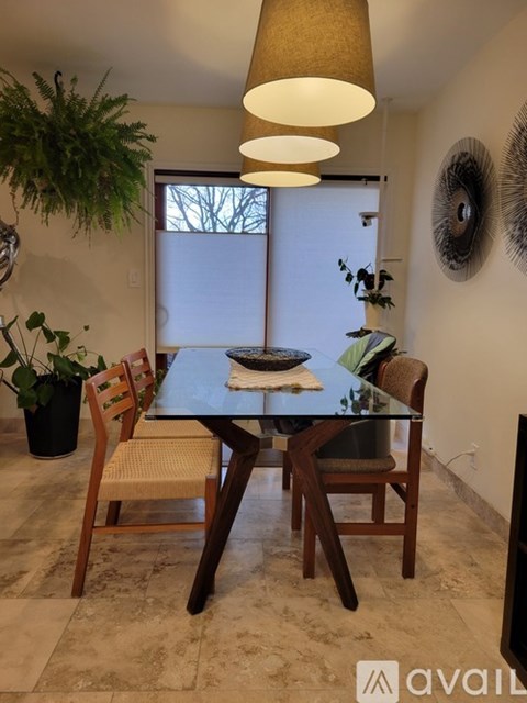 A dining room with a table and chairs.