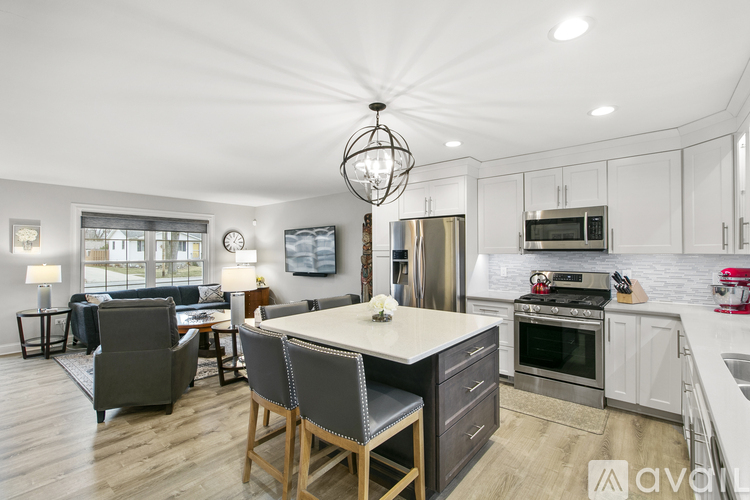A modern kitchen with a dining table and chairs.