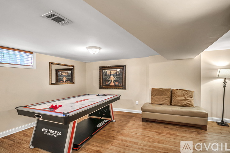 A room with a pool table and a couch.