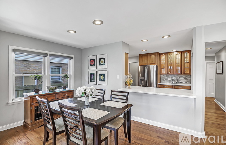 A dining room with a table set for four.