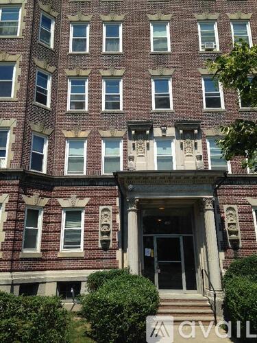 A red brick building with a black door and windows.