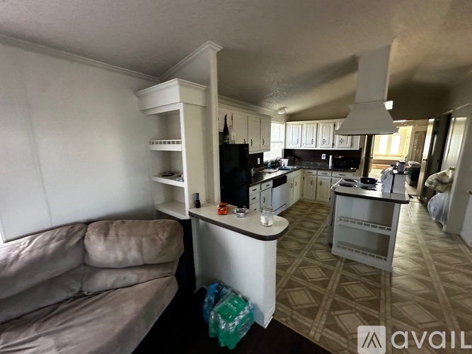 A living room with a couch and a television.