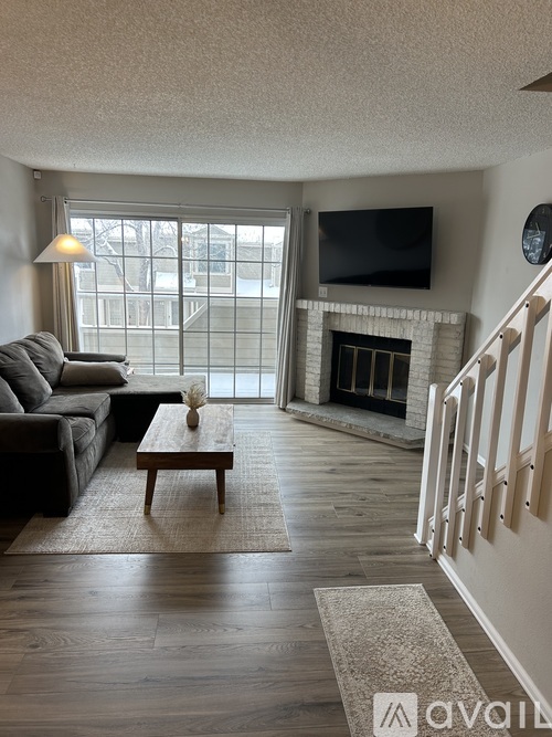 A living room with a fireplace and a television.