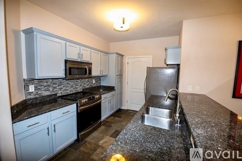 A kitchen with granite countertops and a sink.