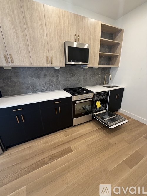 A kitchen with wooden cabinets and a black oven.