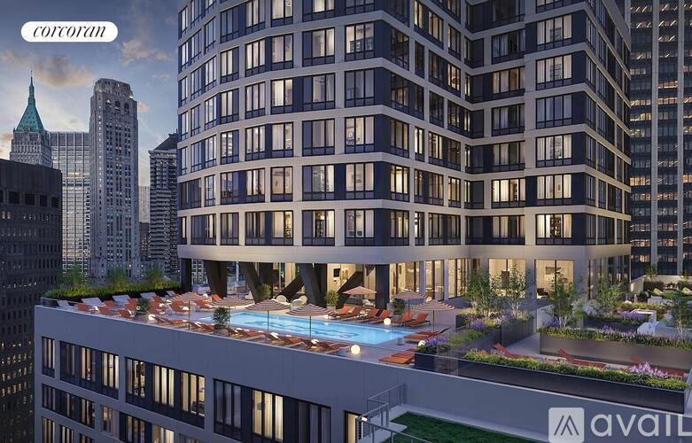 A modern building with a pool in the middle of the terrace.