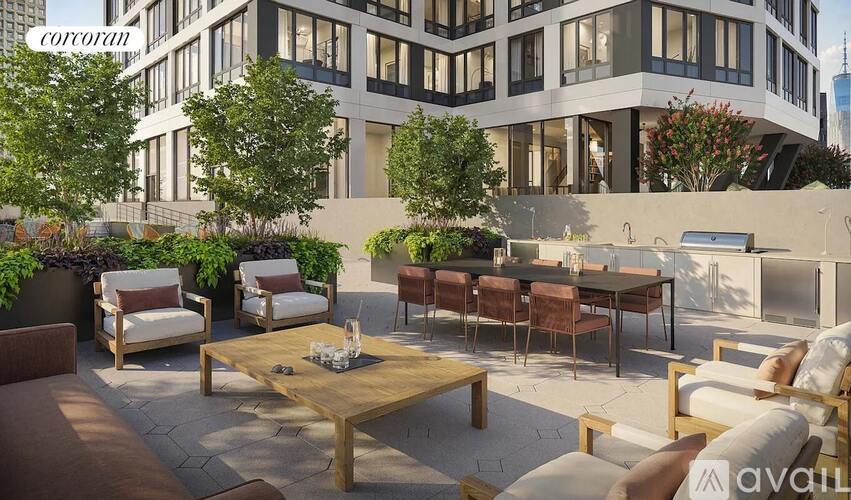 A patio with a table and chairs is in front of a building.