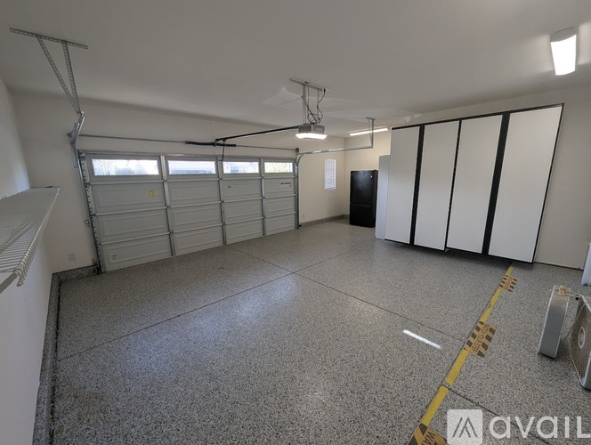 A spacious garage with a concrete floor and white walls.