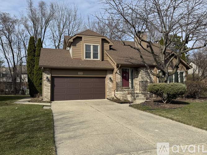 A house with a brown garage door is for sale.