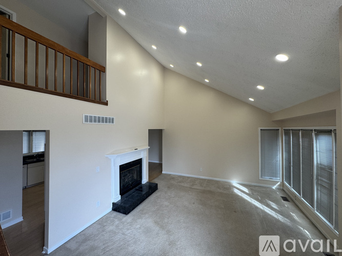 A living room with a fireplace and a carpet.