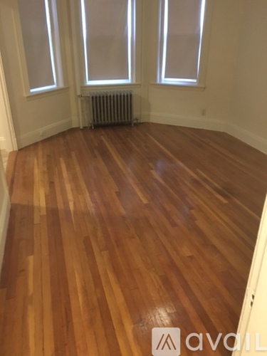 A room with wooden floors and a radiator.