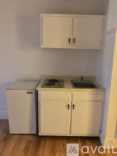 A small kitchen with a sink and a refrigerator.