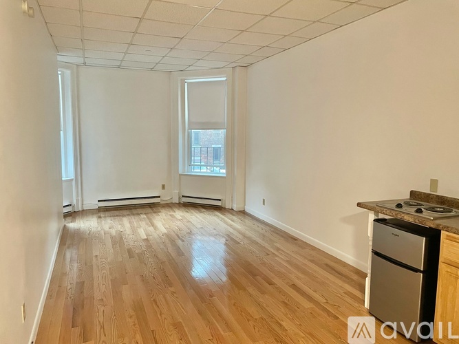 A room with wooden flooring and a window.