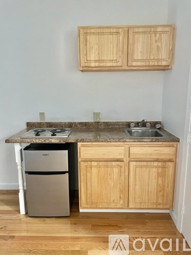 A kitchen with wooden cabinets and a granite countertop.