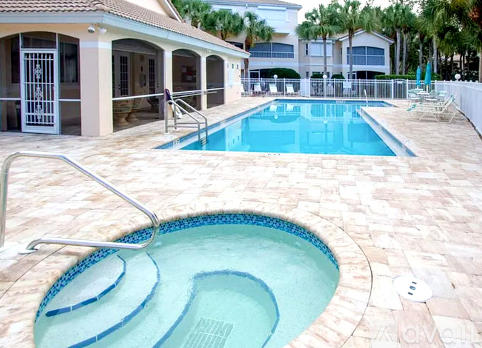 A pool with a slide in the middle of it.