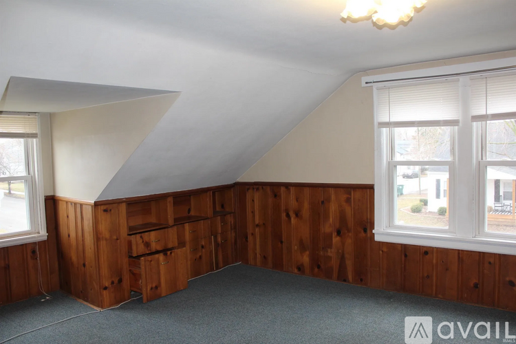 A room with wooden walls and a window.