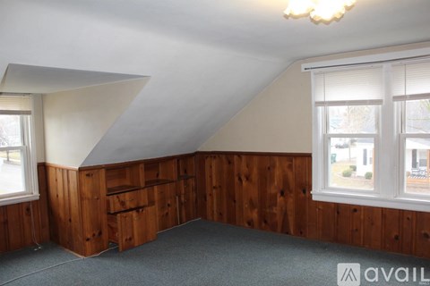 A room with wooden walls and a window.