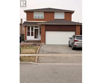A house with a garage and a car parked in front.