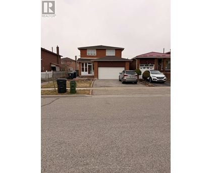 A house with a brown roof and a driveway in front of it.