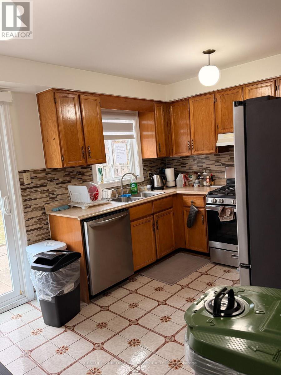 A kitchen with wooden cabinets and a green stove top.
