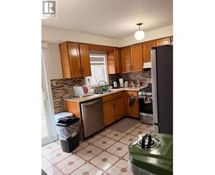 A kitchen with wooden cabinets and a green stove top.
