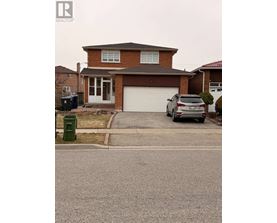 A house with a brown roof and a grey car parked in front.