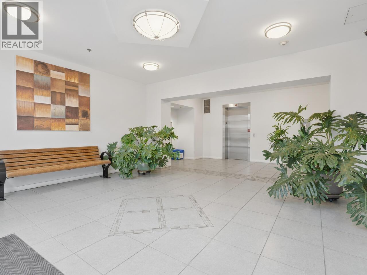 A REALTOR® logo is on the wall in a spacious room.