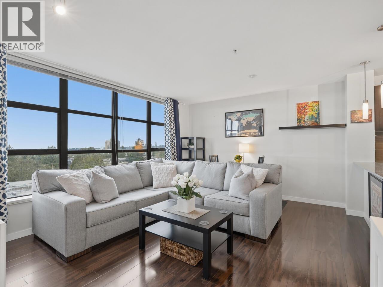 A living room with a grey couch and a coffee table.