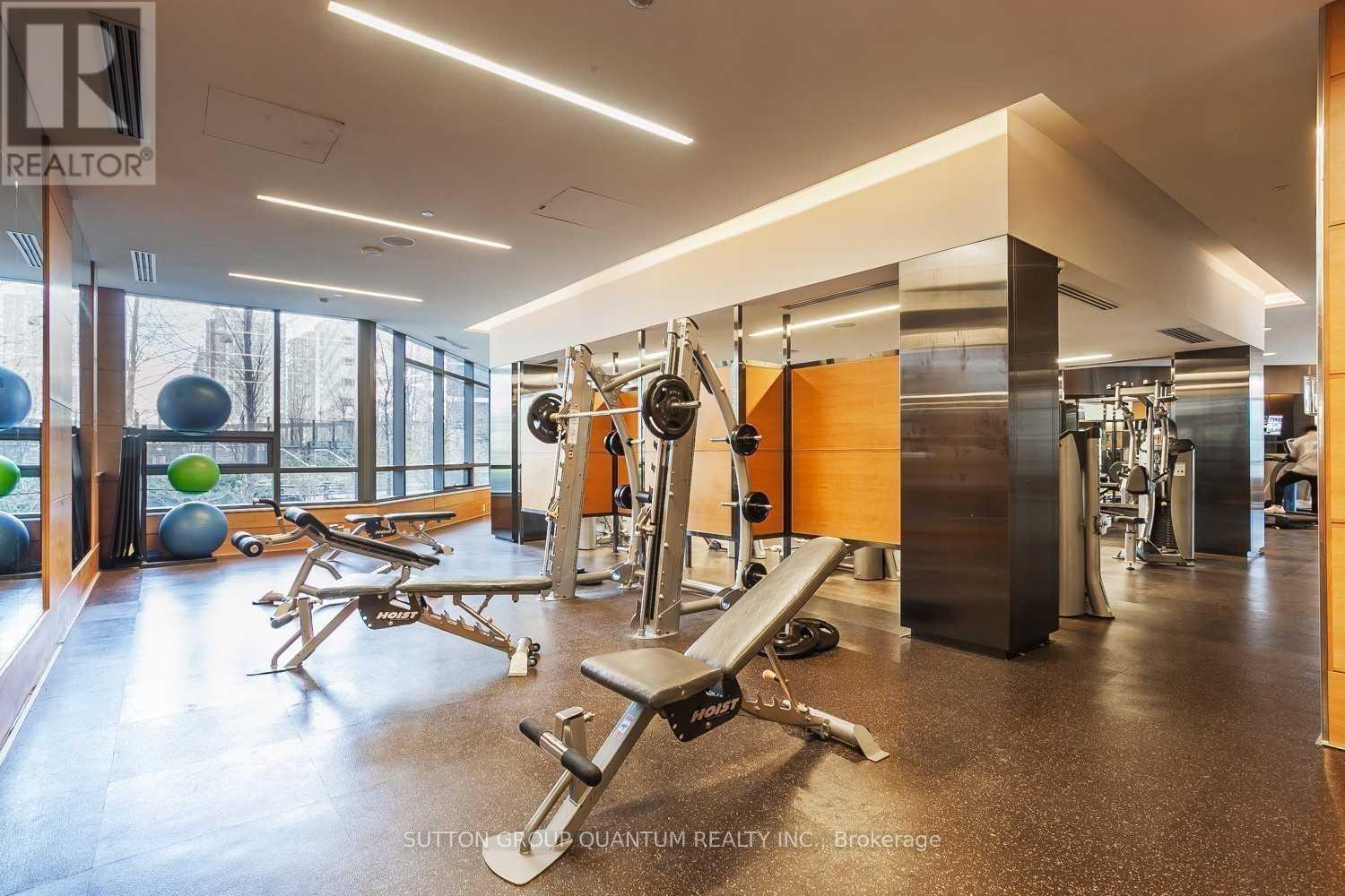 A gym with a variety of equipment including a bench press.