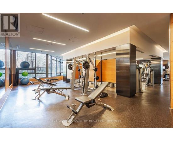 A gym with a variety of equipment including a bench press.