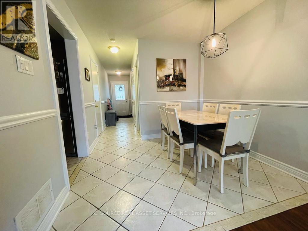 A dining room with a table and chairs.