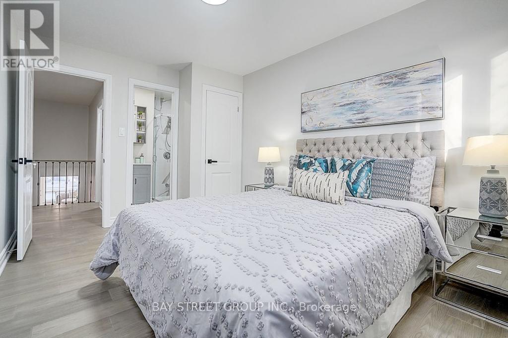 A bedroom with a large bed and a painting on the wall.