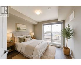 A bedroom with a large bed and a window overlooking a parking lot.